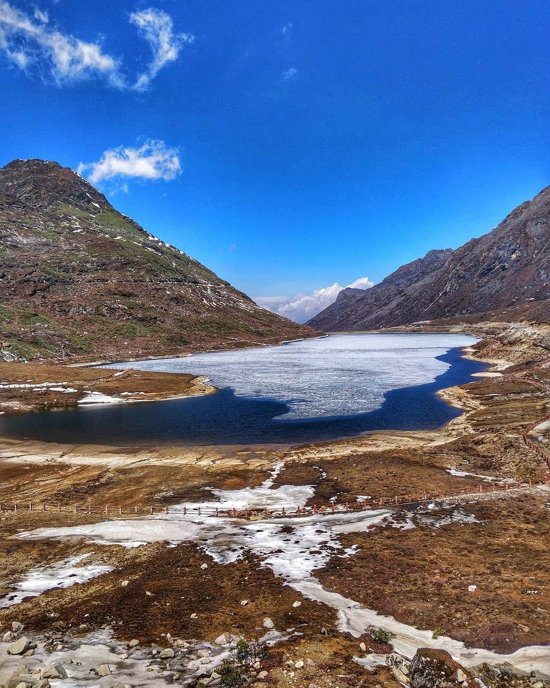 The picturesque Sela Lake, nestled among snow-capped mountains at the Sela Pass in Arunachal Pradesh.